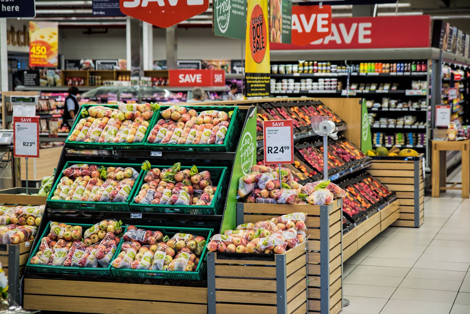 Supermarket produce aisle with discount signage