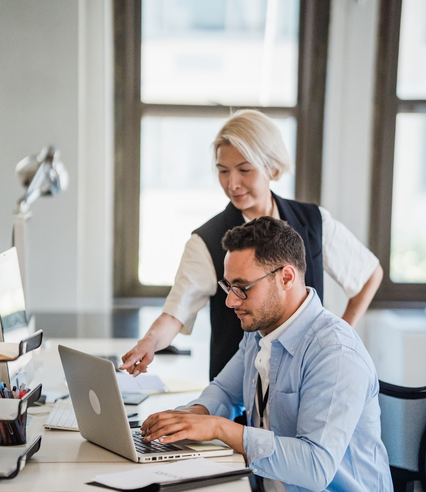 Consultant and planner reviewing a plan on a laptop