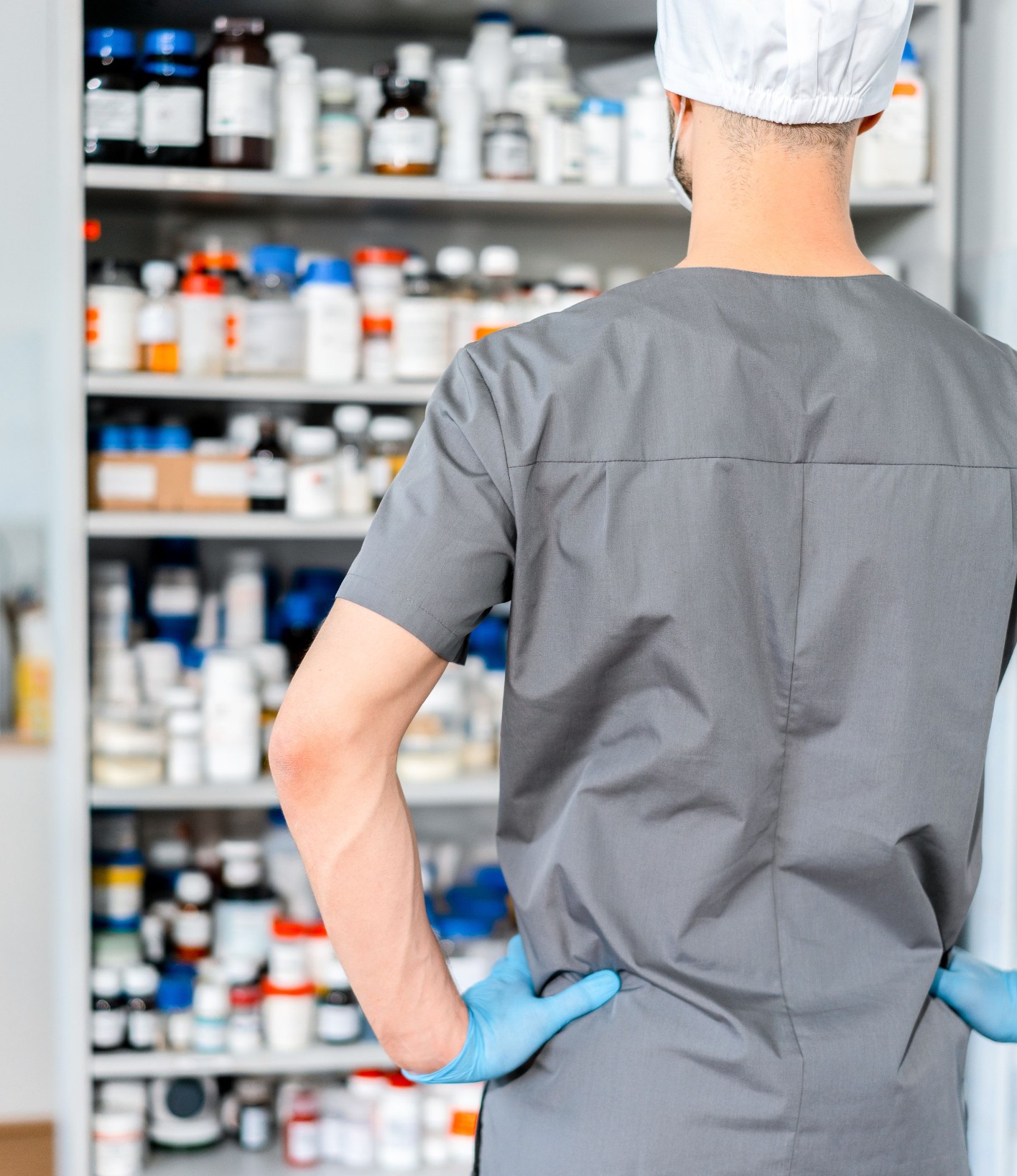 Pharmacist at pharmacy shelves